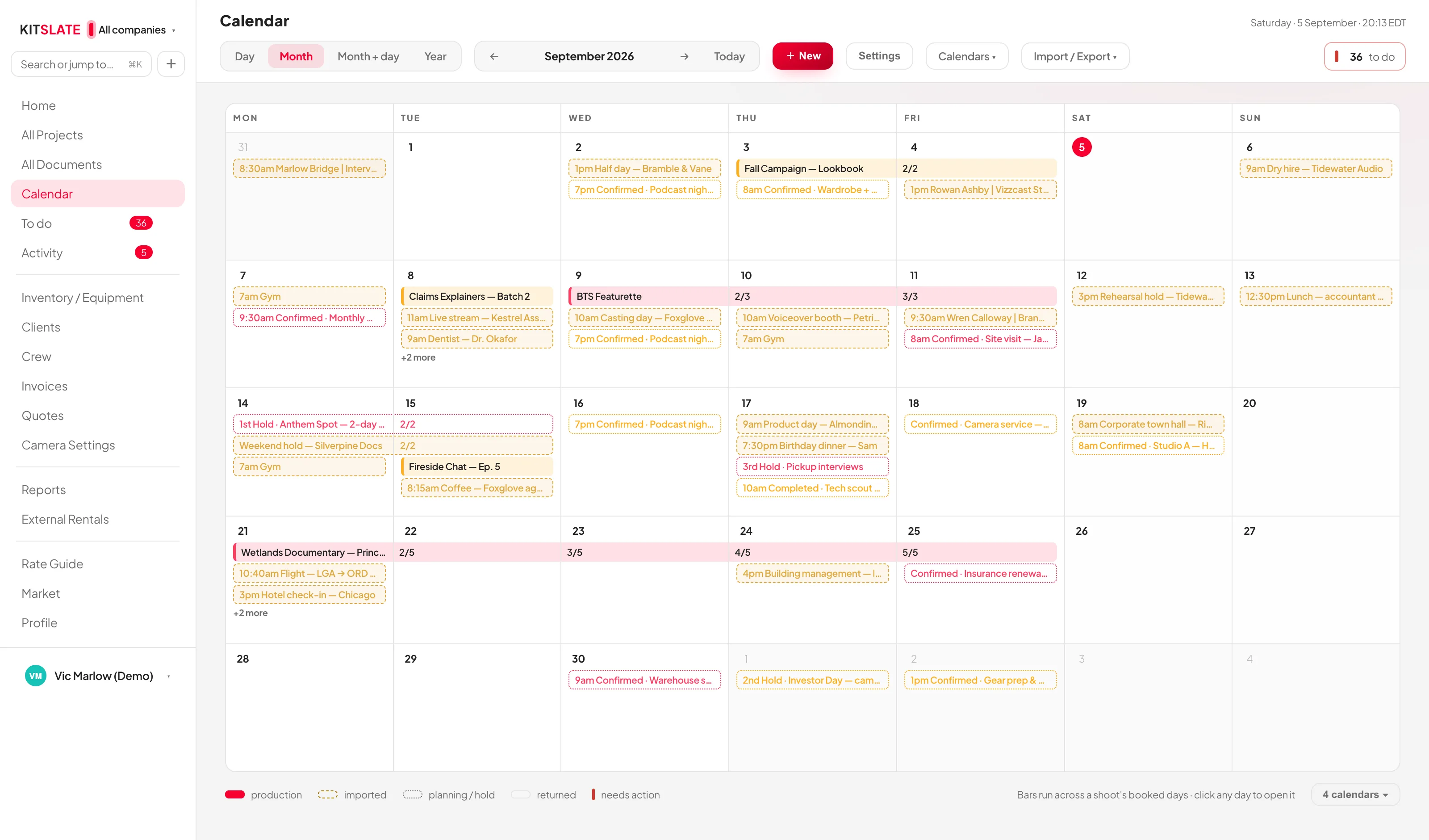 The KitSlate month calendar with two companies colour-separated, shoot bars running across booked days, holds, confirmations and imported calendar feeds